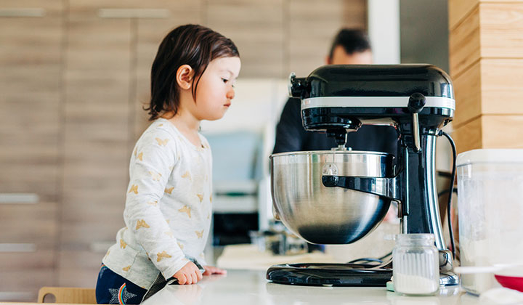 Toddler with a black stand mixer