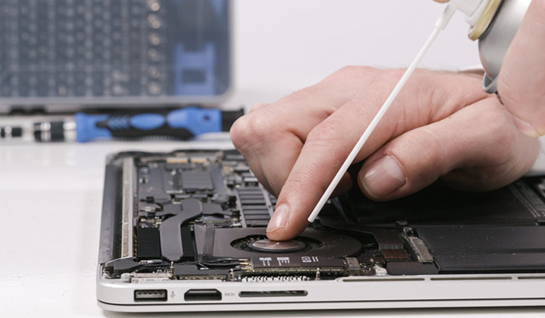 Laptop being cleaned with compressed air