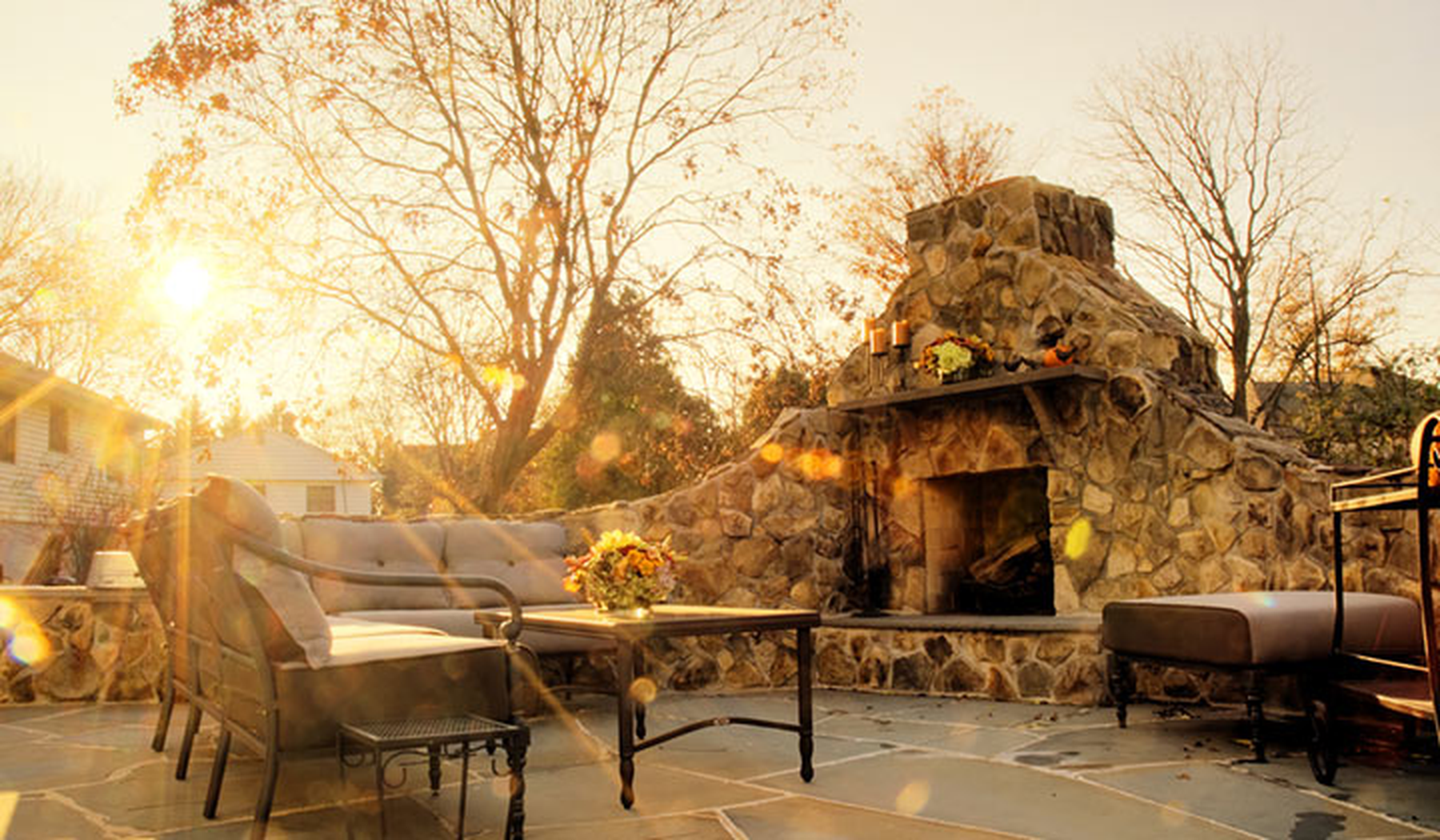 Fall afternoon lighting an outdoor fireplace and patio