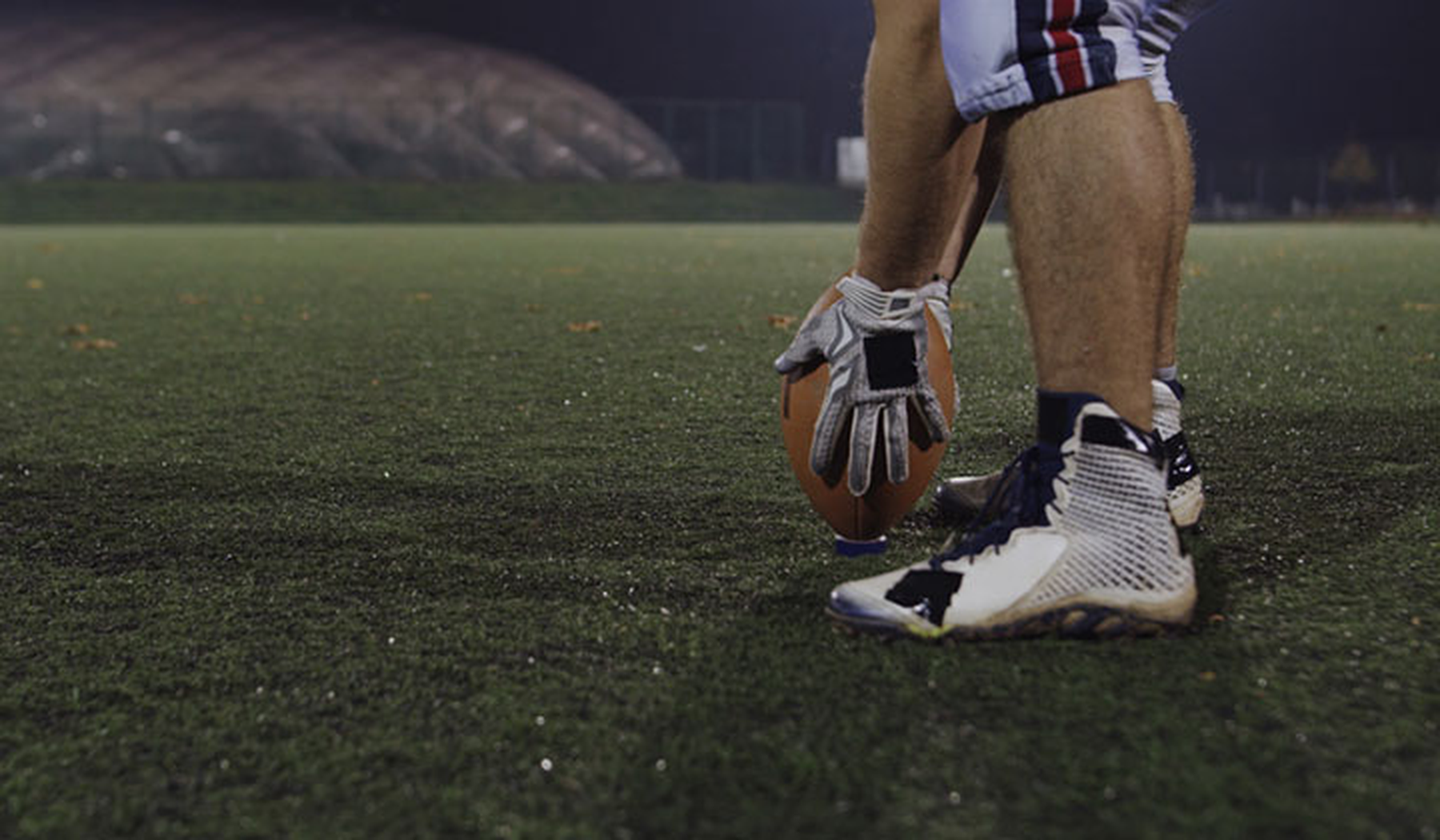 American football player on field at night