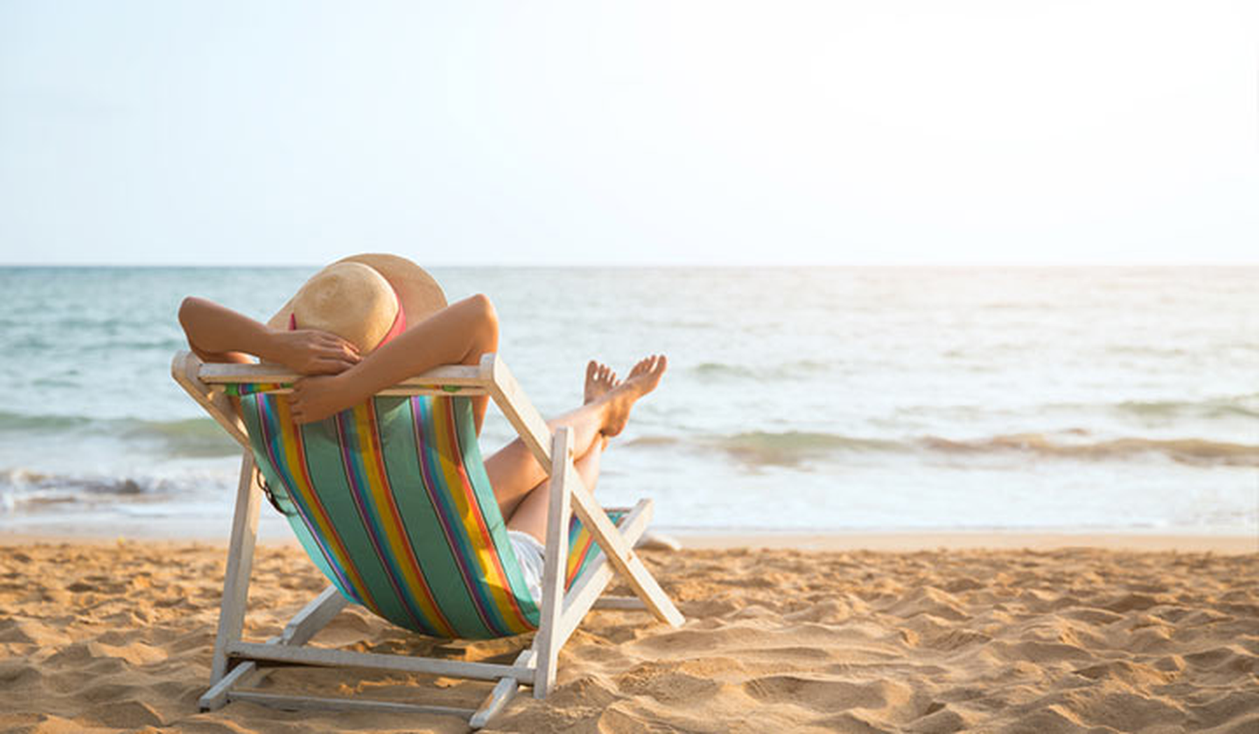 Woman relaxing on a lounge chair on the beach