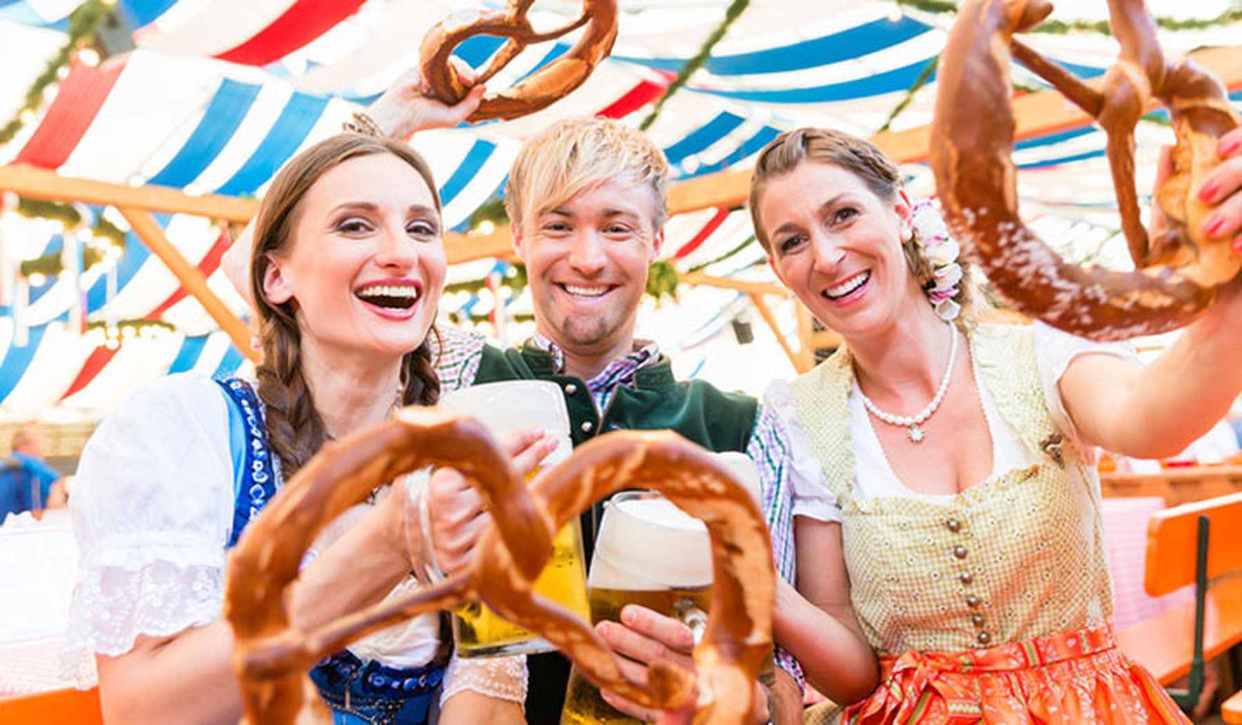 Three young people in a beer tent at Oktoberfest