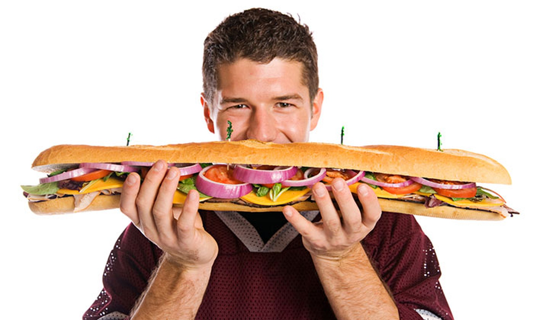 Young man holding a sub sandwich