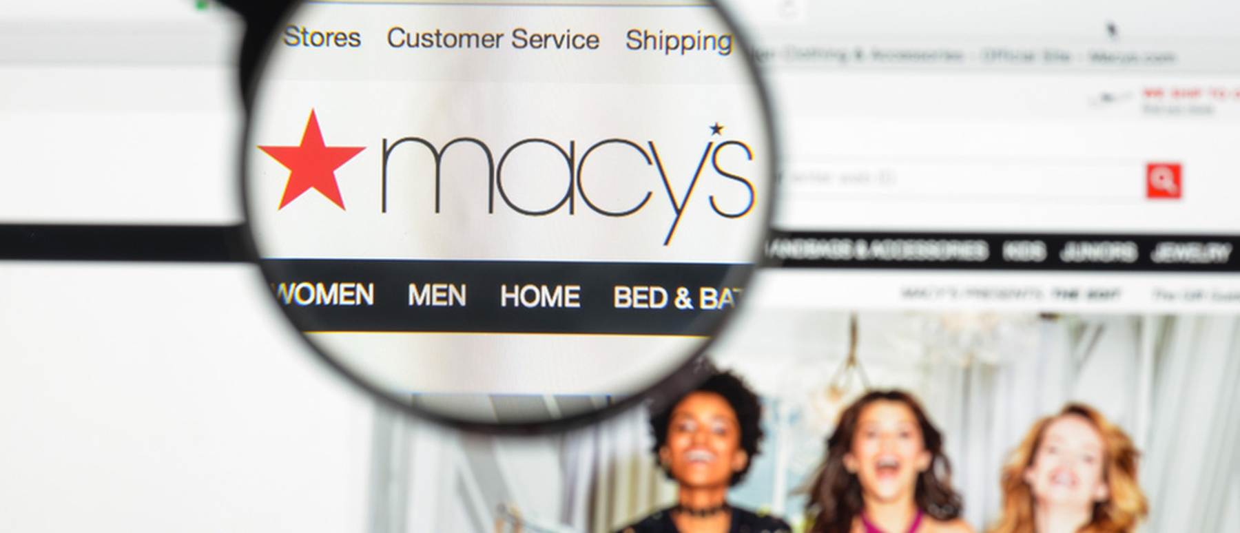Magnifying glass showing the Macy's logo on their homepage