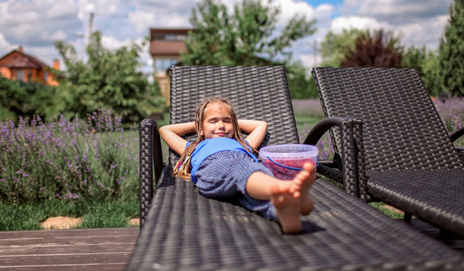 Young girl relaxing on a lounger in the sun
