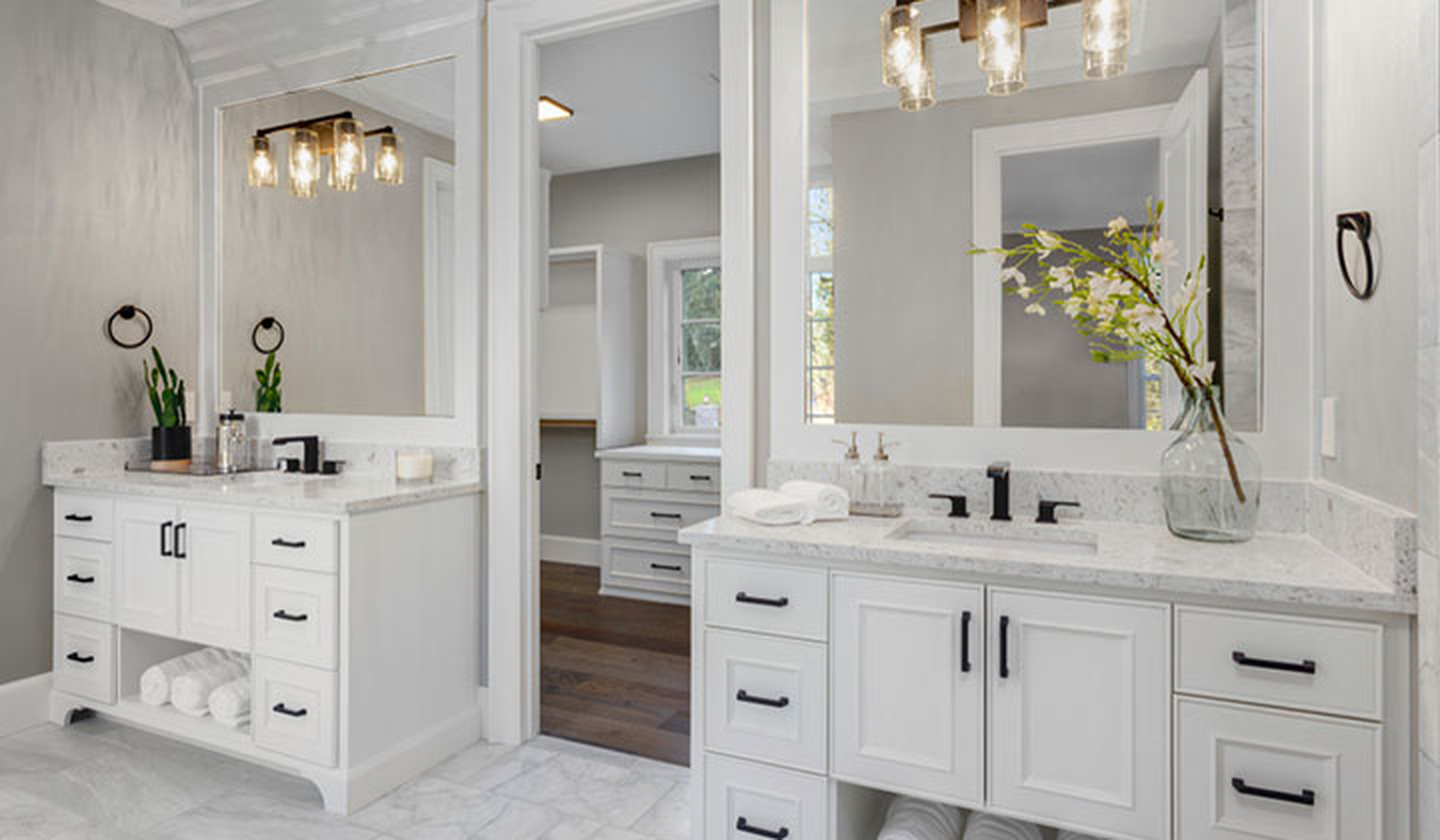 Modern bathroom with white two white vanities and white tile