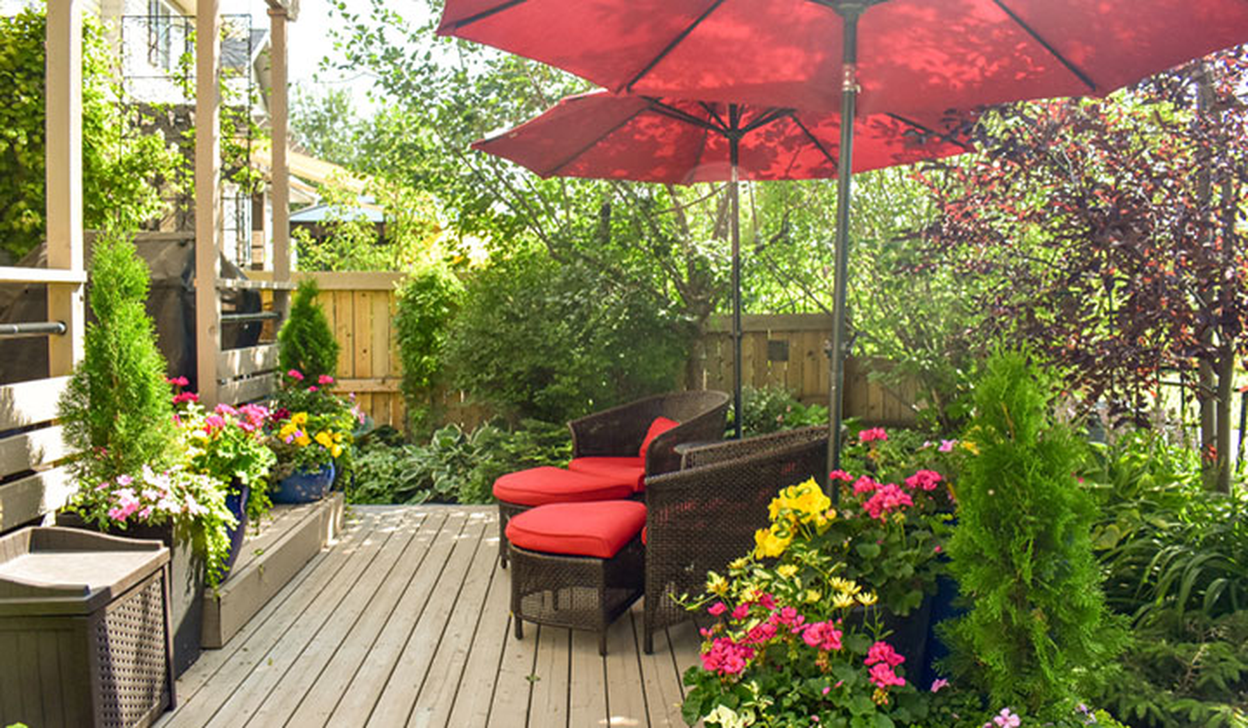 Patio set with red cushions and a red umbrella