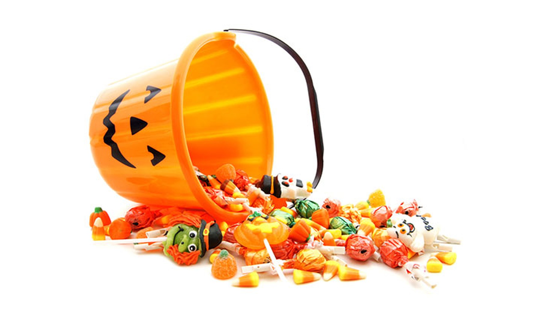 Pumpkin treat bucket with candy spilling out