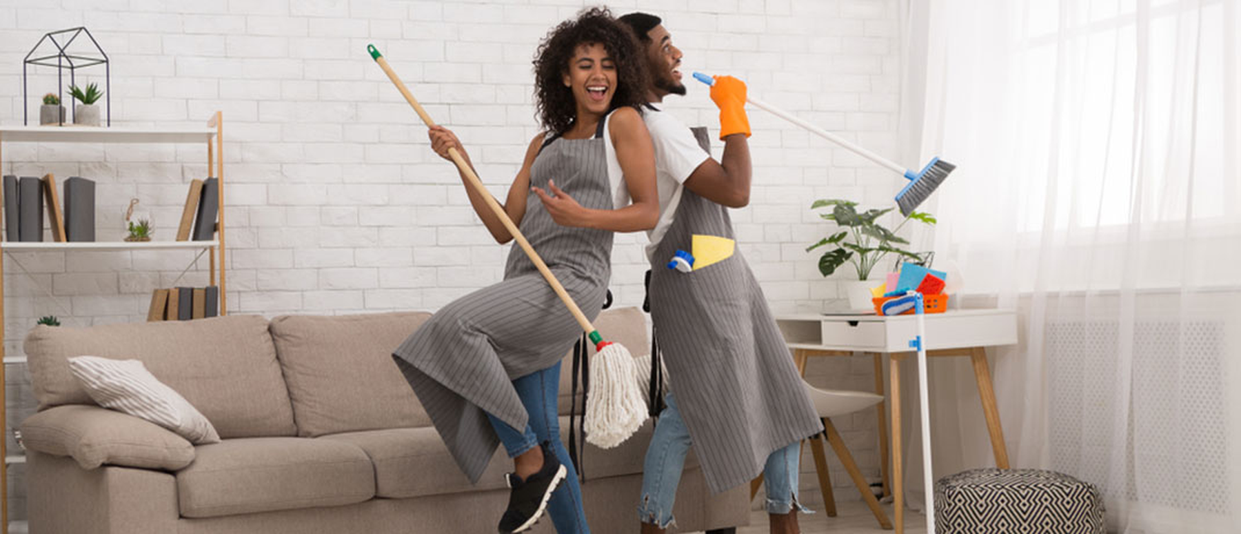 Young couple cleaning their home
