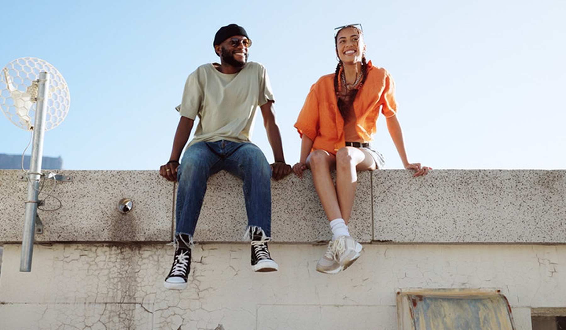 Young man and woman wearing Converse