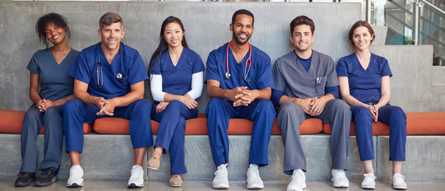 Group of medical providers sitting on a bench