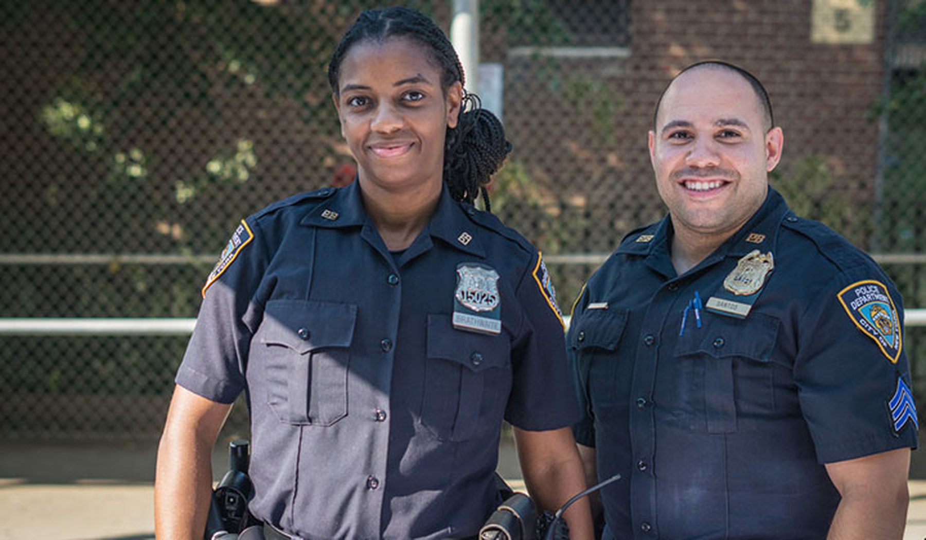 Smiling man and woman police officers