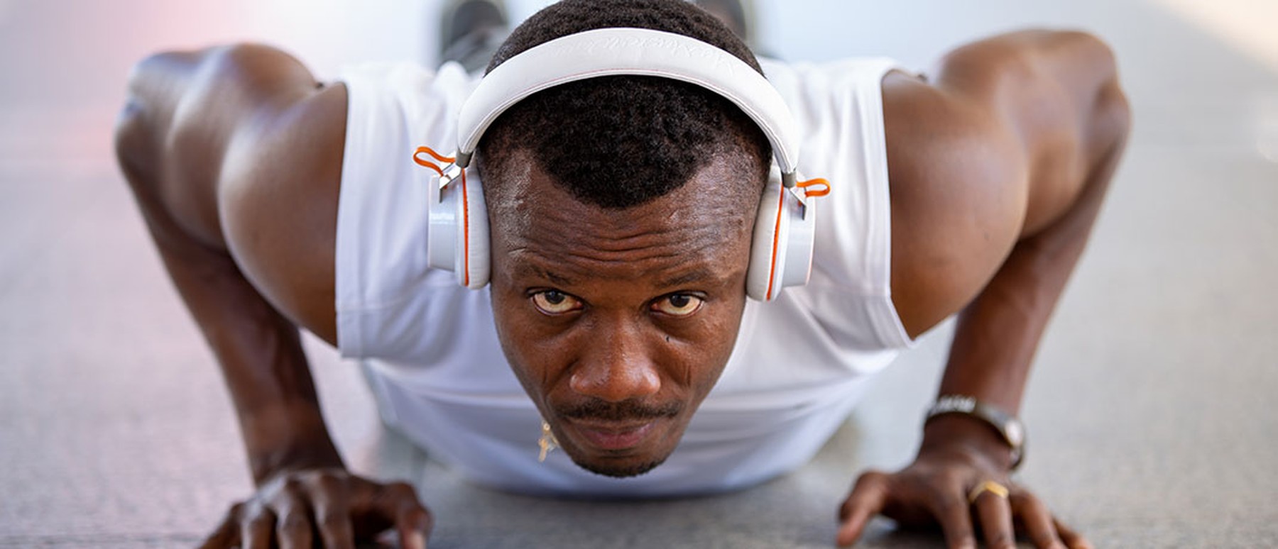 Man wearing headphones while doing pushups