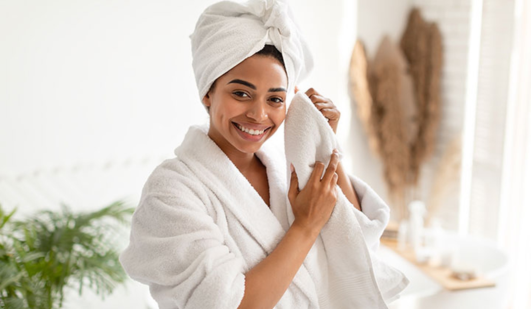 Woman holding soft towel in the bathroom