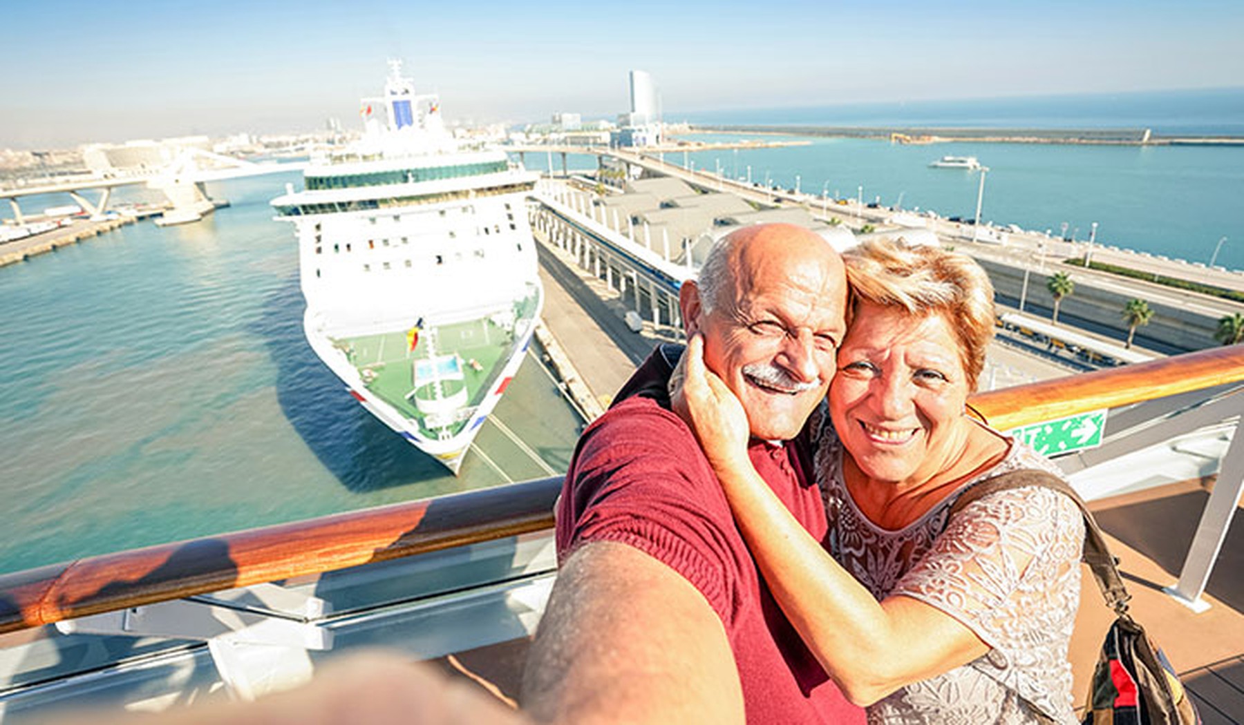 Happy older couple taking selfie on a cruise ship